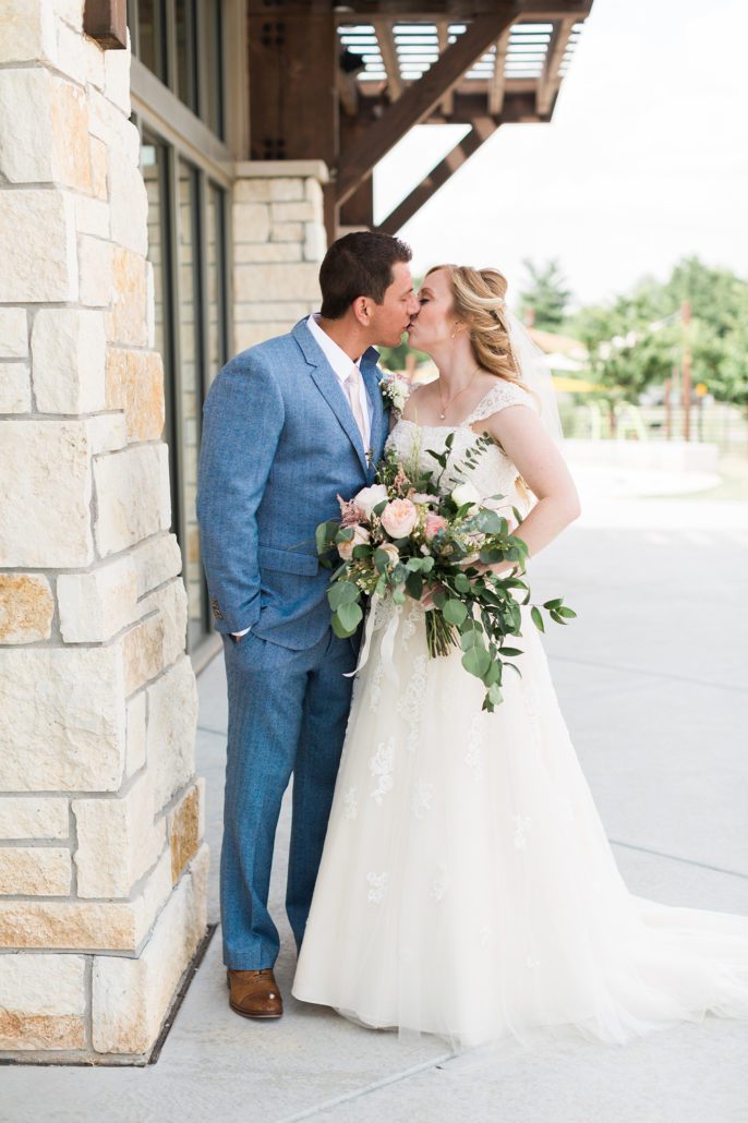 groom and bride kissing